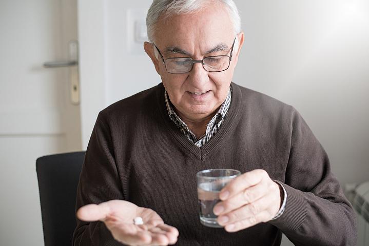 Elderly man with medicine Elderly man with medicine