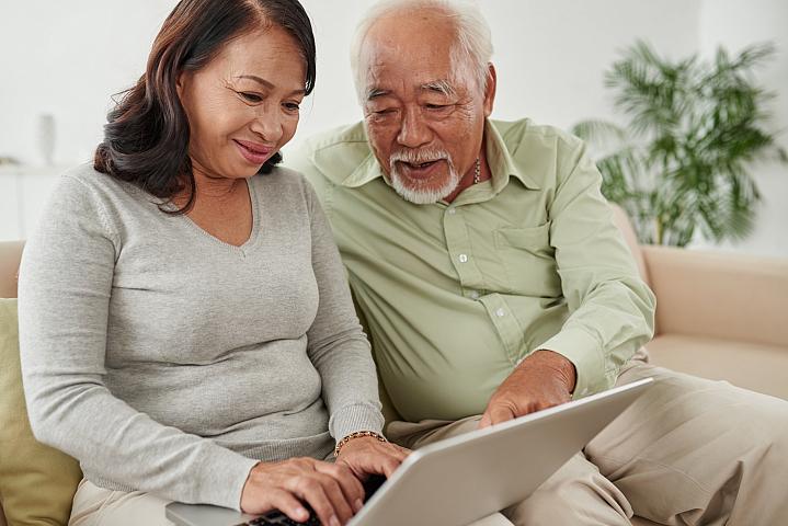 Older couple looking up health information on a laptop