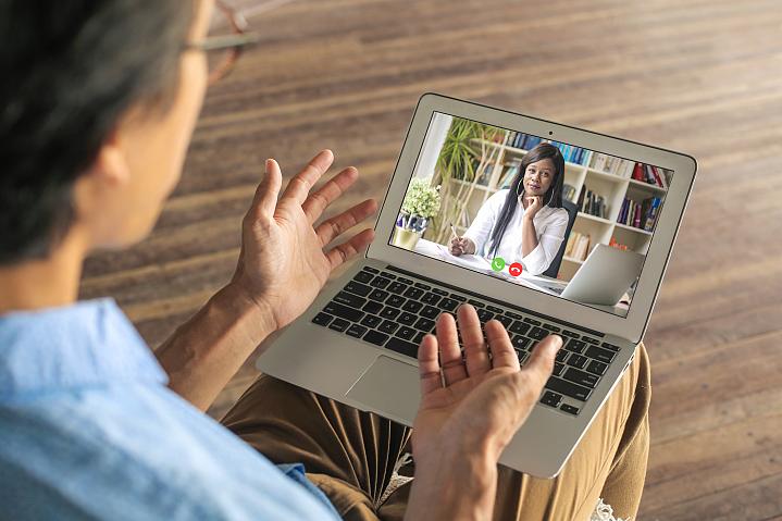 Man talking with his mental health provider over video chat Man talking with his mental health provider over video chat