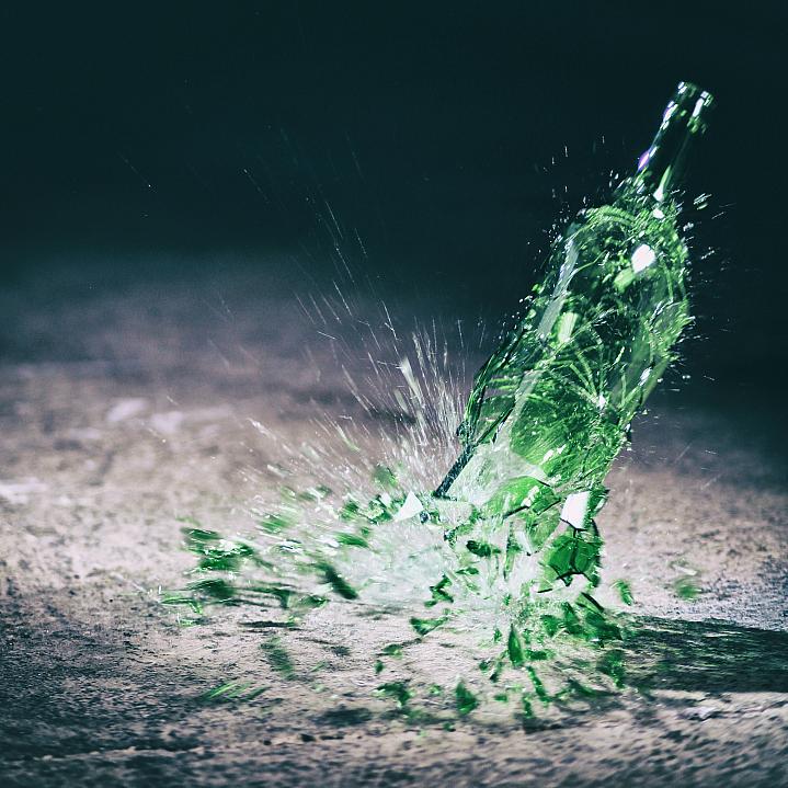 Green wine bottle hitting the floor and breaking Green wine bottle hitting the floor and breaking