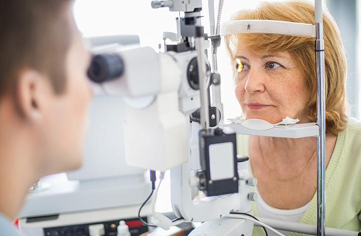 Older woman getting her eyes checked at the eye doctor Older woman getting her eyes checked at the eye doctor