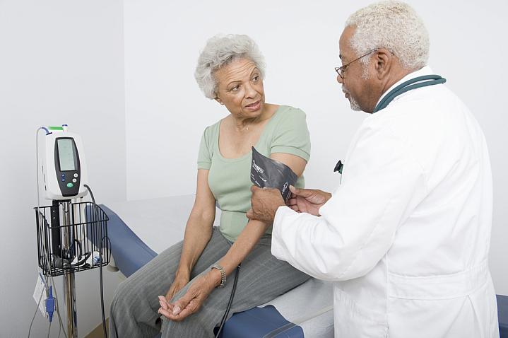 Doctor measuring blood pressure of a senior black woman Doctor measuring blood pressure of a senior black woman