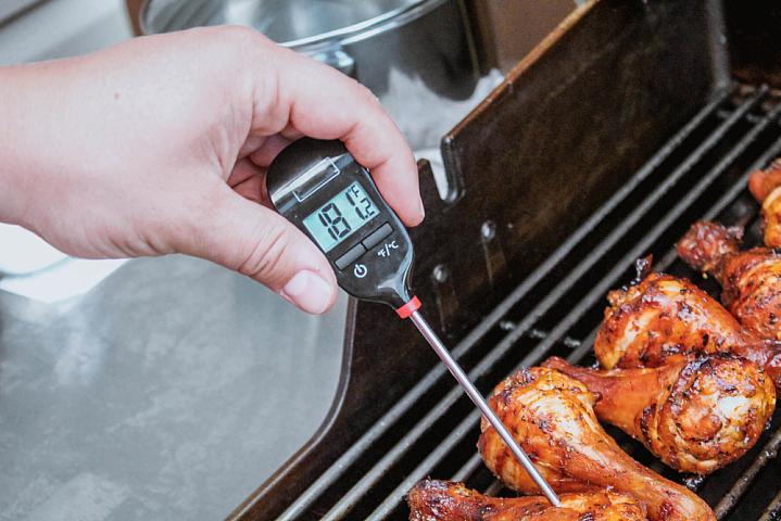 Thermometer showing temperature of chicken that’s being grilled Thermometer showing temperature of chicken that’s being grilled
