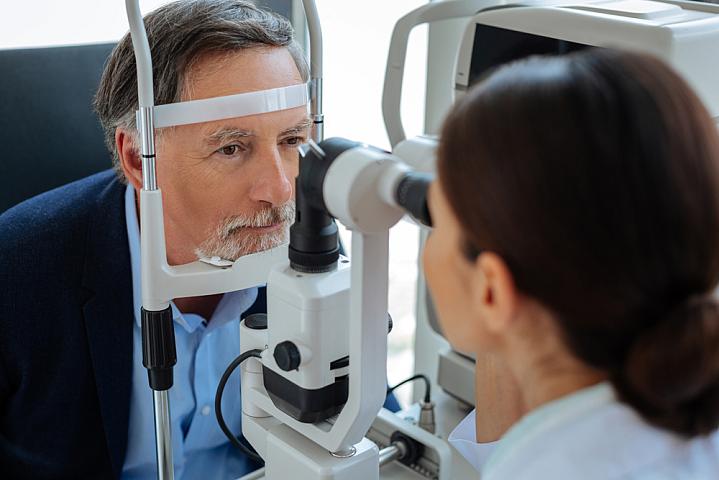 An older man getting an eye exam An older man getting an eye exam