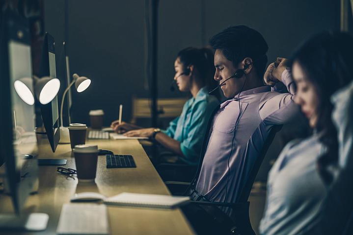 Tired night shift workers in office Tired night shift workers in office