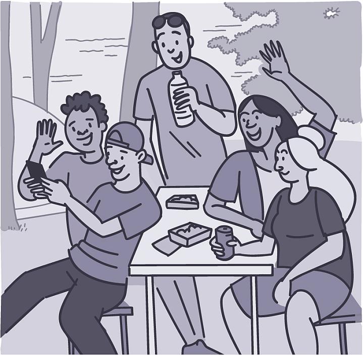 Group of friends taking a selfie outside at a picnic table Group of friends taking a selfie outside at a picnic table