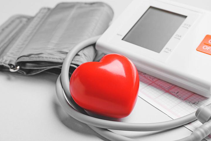 Modern blood pressure monitor with red heart Modern blood pressure monitor with red heart