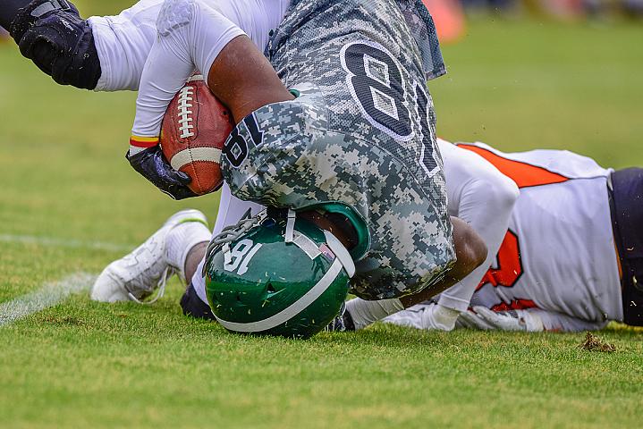 High school football player landing on their head High school football player landing on their head.